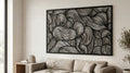 Puede incluir: Una gran obra de arte mural rectangular en blanco y negro con un diseño abstracto y fluido. La obra presenta una serie de líneas curvas, creando un patrón similar a las olas. La pieza está enmarcada en negro y cuelga sobre un sofá beige.