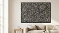 Puede incluir: Arte mural en blanco y negro con un diseño de espirales arremolinadas. La obra de arte, enmarcada en negro, cuelga sobre un sofá beige. El diseño consiste en formas circulares repetidas, creando un efecto visual dinámico.
