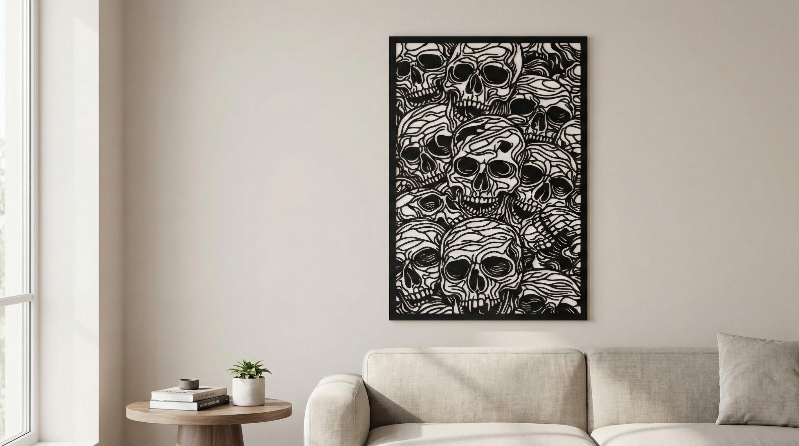 Puede incluir: Obra de arte enmarcada en blanco y negro que representa numerosas calaveras. La obra de arte se exhibe sobre un sofá beige en un salón moderno. Las calaveras tienen detalles de líneas intrincadas.