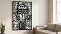 Puede incluir: Arte mural abstracto en blanco y negro con un diseño geométrico de rostro. La obra de arte está enmarcada en negro y montada sobre un fondo blanco. La pieza se exhibe en un salón.