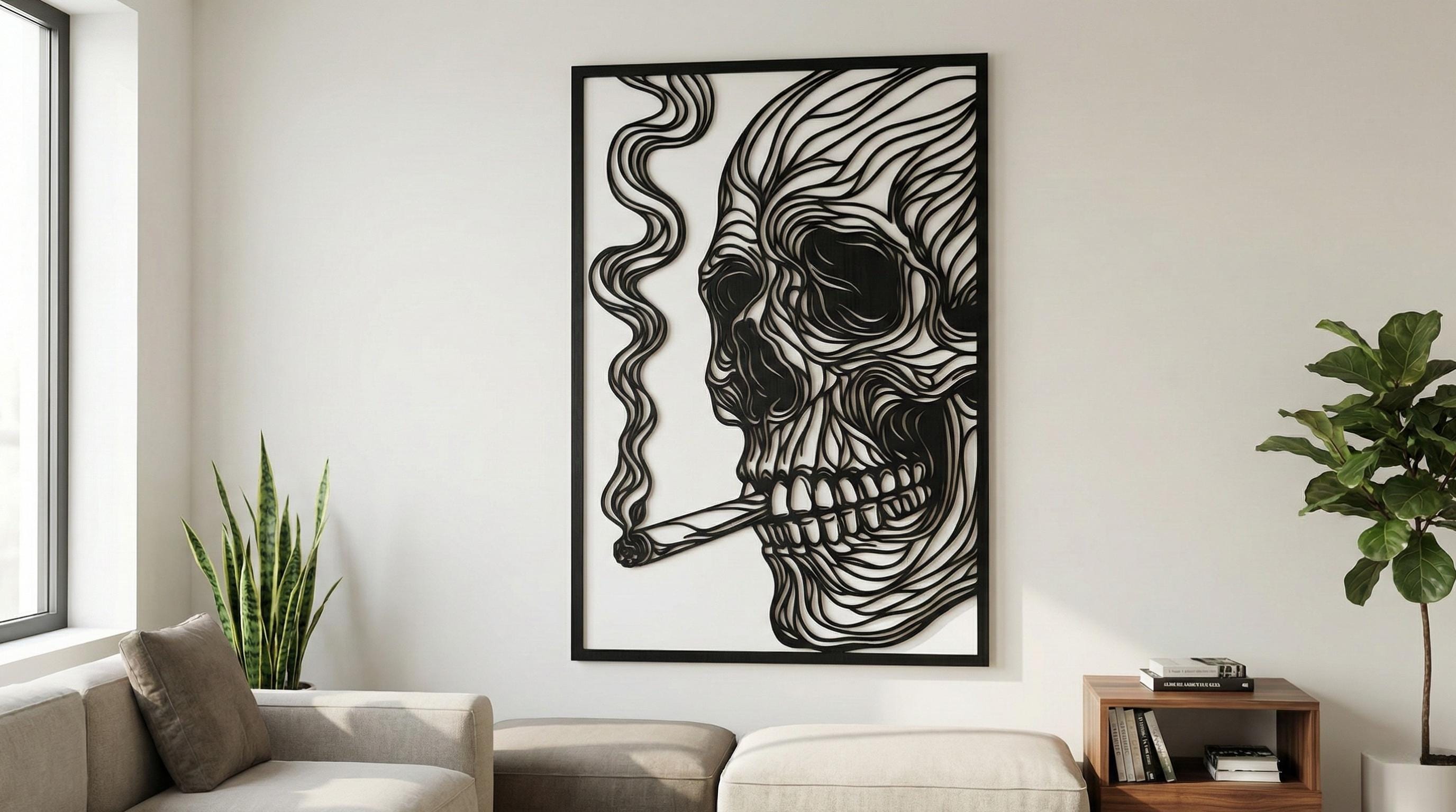 Puede incluir: Arte mural en blanco y negro que representa una calavera fumando un cigarro. La obra de arte está enmarcada en negro y tiene un diseño en capas único. Los rasgos de la calavera están intrincadamente tallados, con humo que se eleva del cigarro.